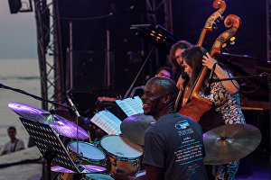 Members of Double Bass Project, from left: Gregory Hutchinson, Darya Sokolova and Makar Novikov perform at the Koktebel Jazz Party 2017 festival